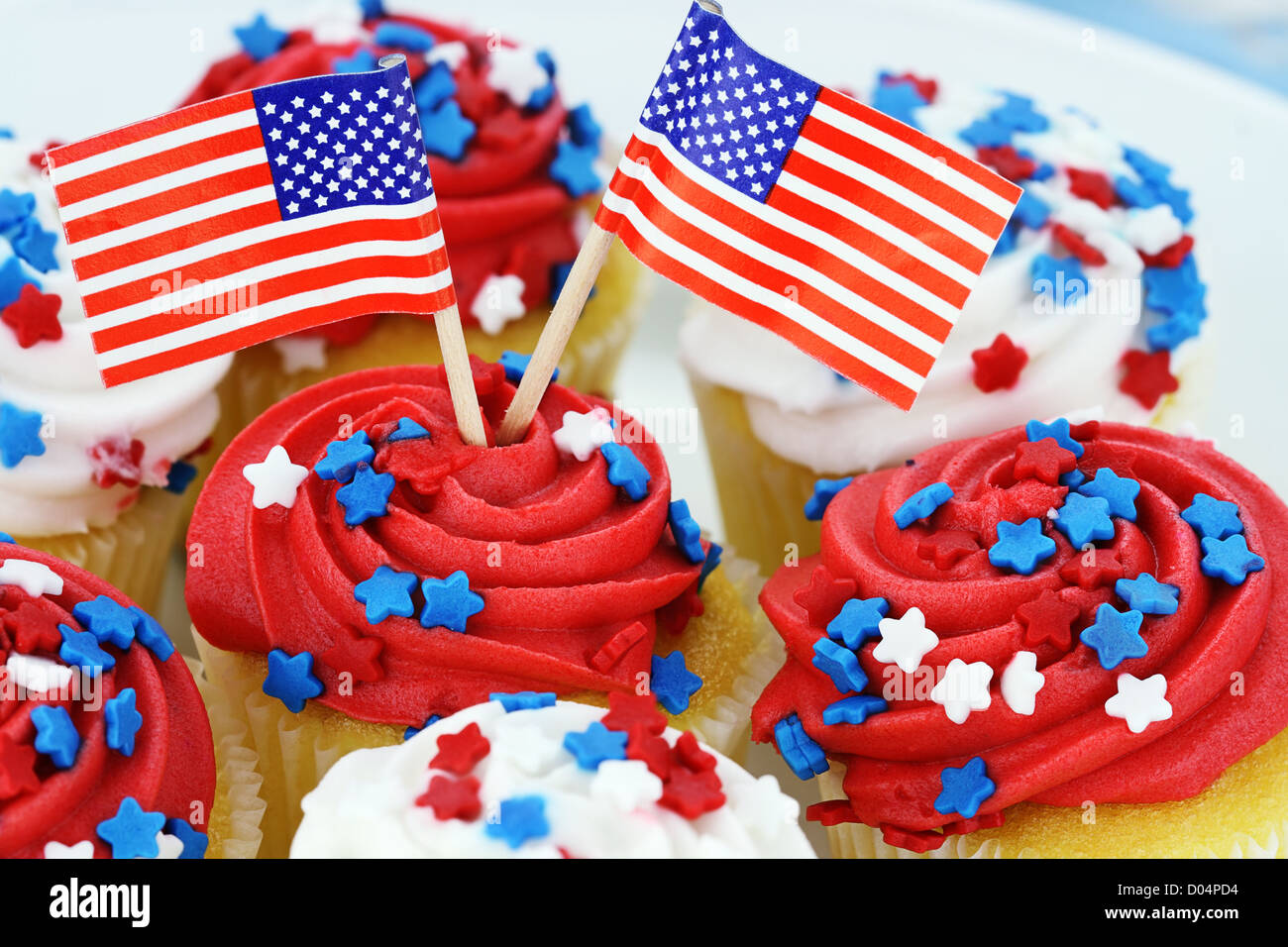 American patriotic themed cupcakes for the 4th of July Shallow depth of field with selective focus on flags and center cupcake. Stock Photo