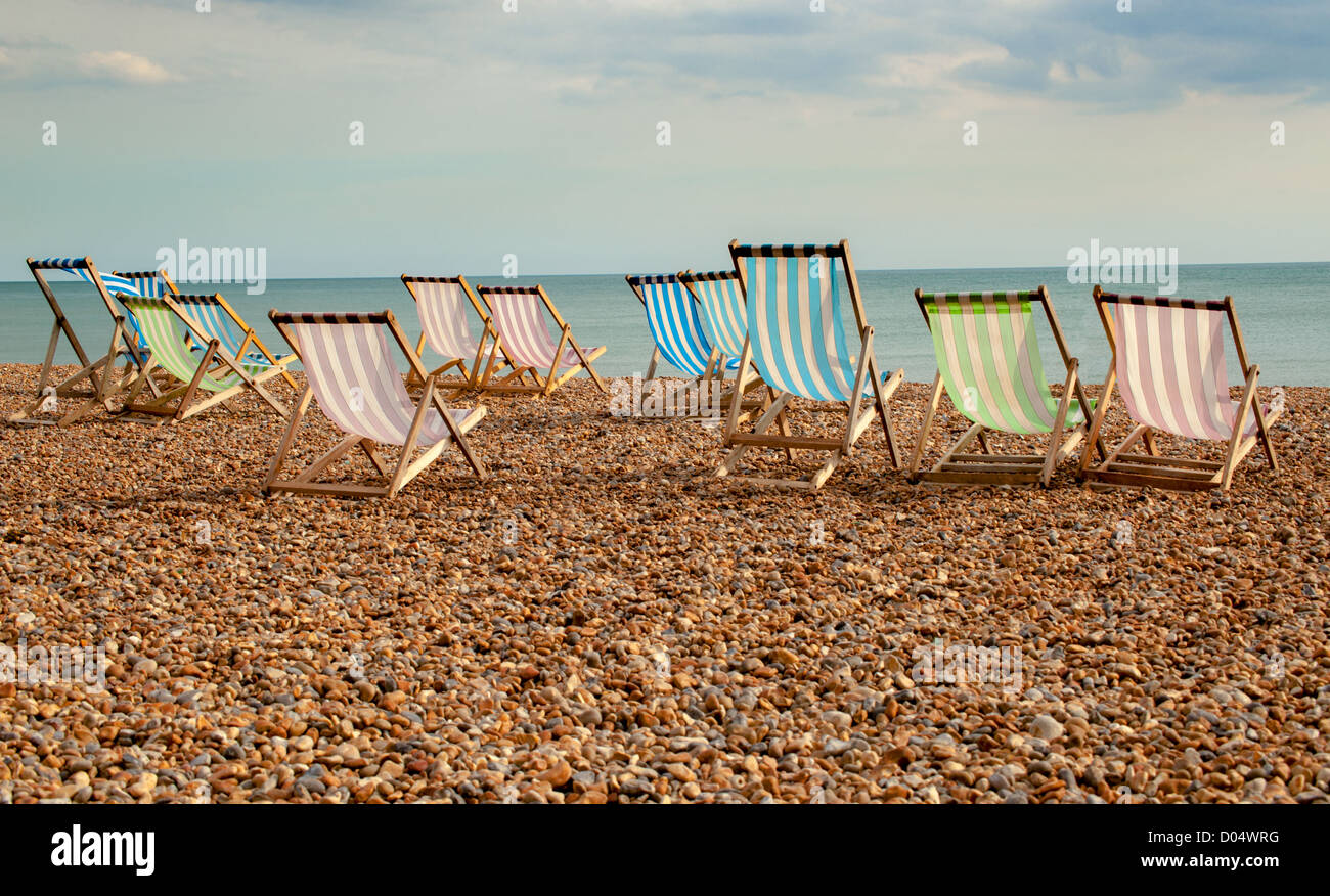 Deck chairs on Brighton beach, UK Stock Photo
