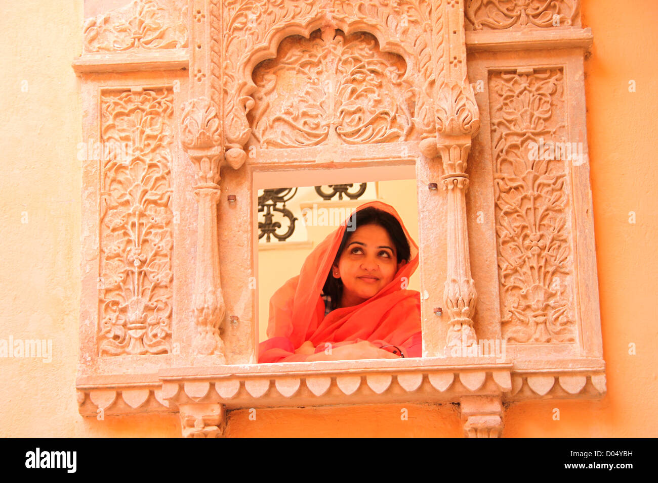 A Rajasthani woman peeping through the jharokha ( window) Stock Photo