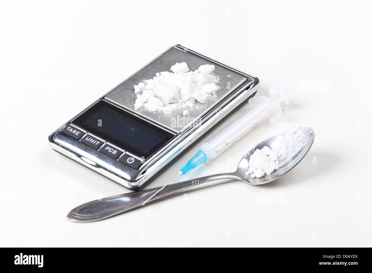 Syringe and digital scales with drugs closeup on white  Stock Photo