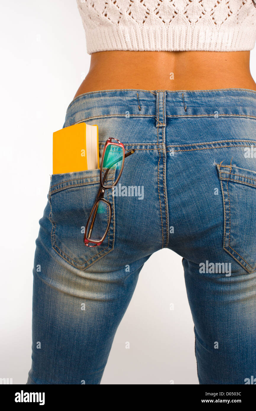A small dictionary sticking out of a sexy jeans back pocket Stock Photo -  Alamy