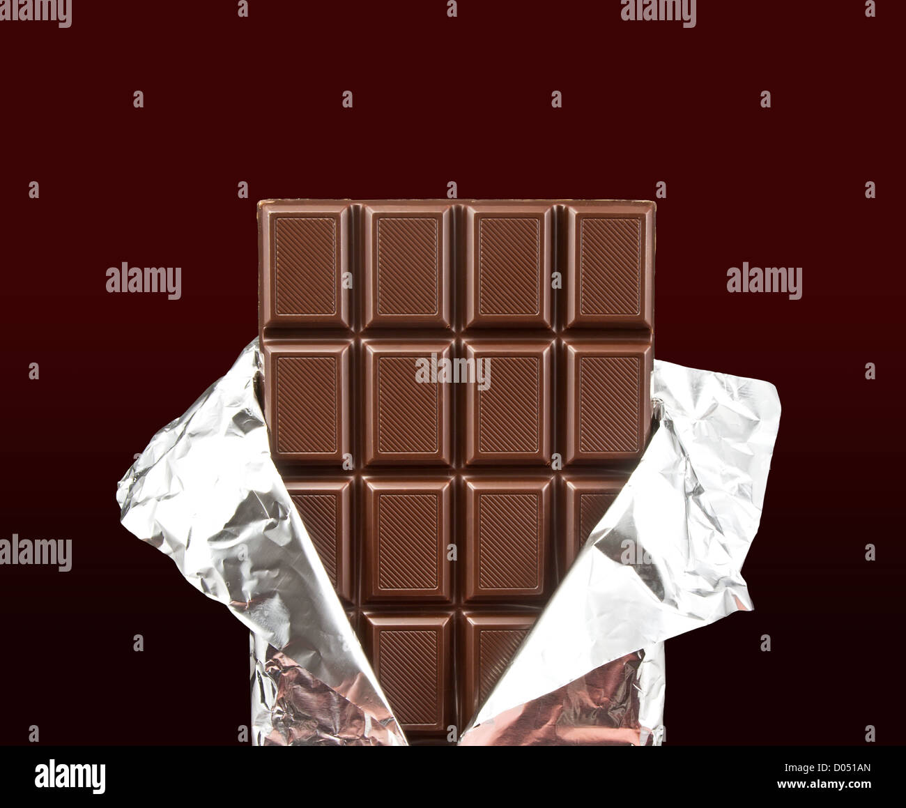 chocolate bar with open cover on dark background Stock Photo