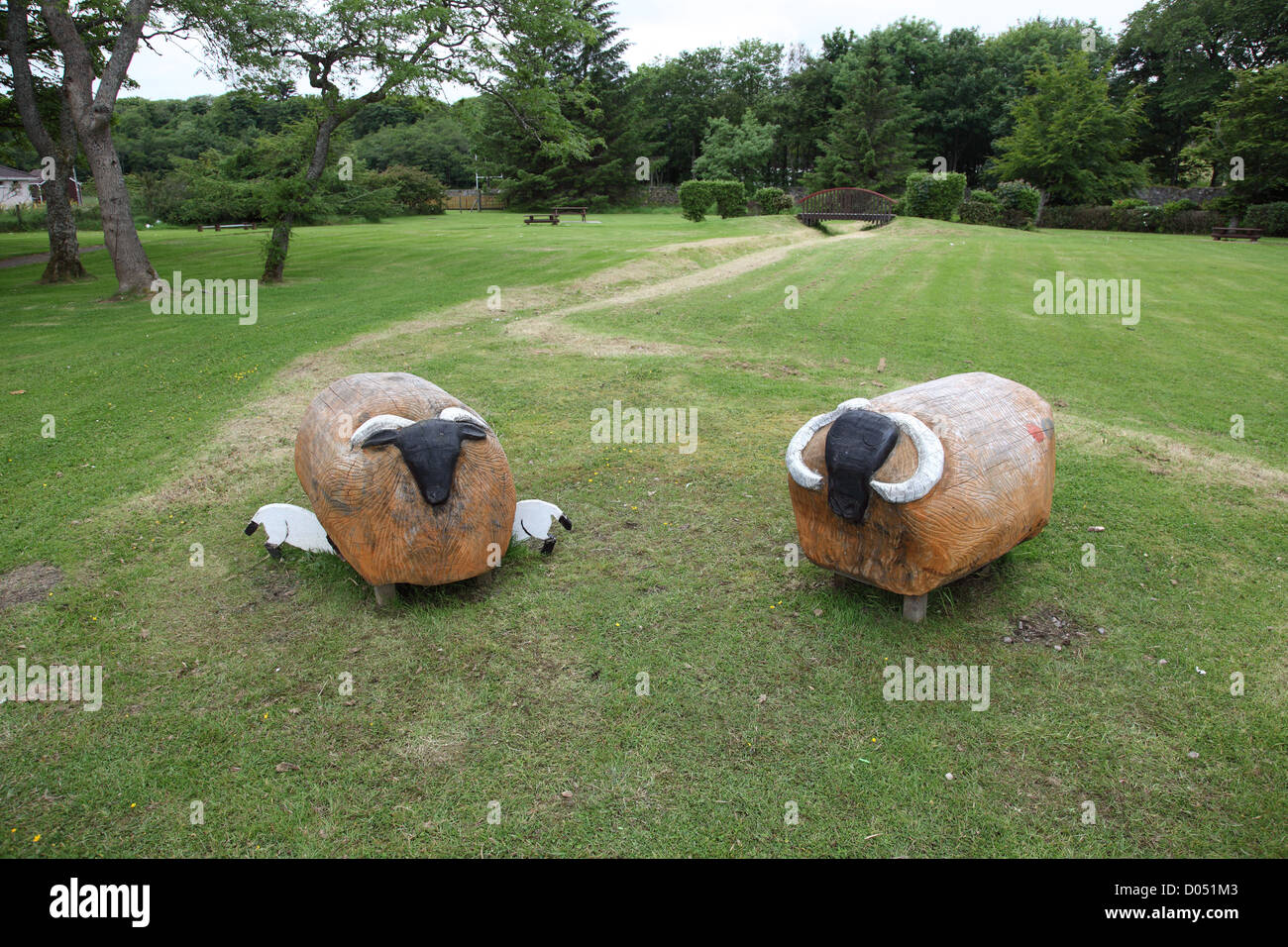 two carved wooden sheep seen by the roadside in Stornaway on the Isle of Lewis in the outer hebrides Stock Photo