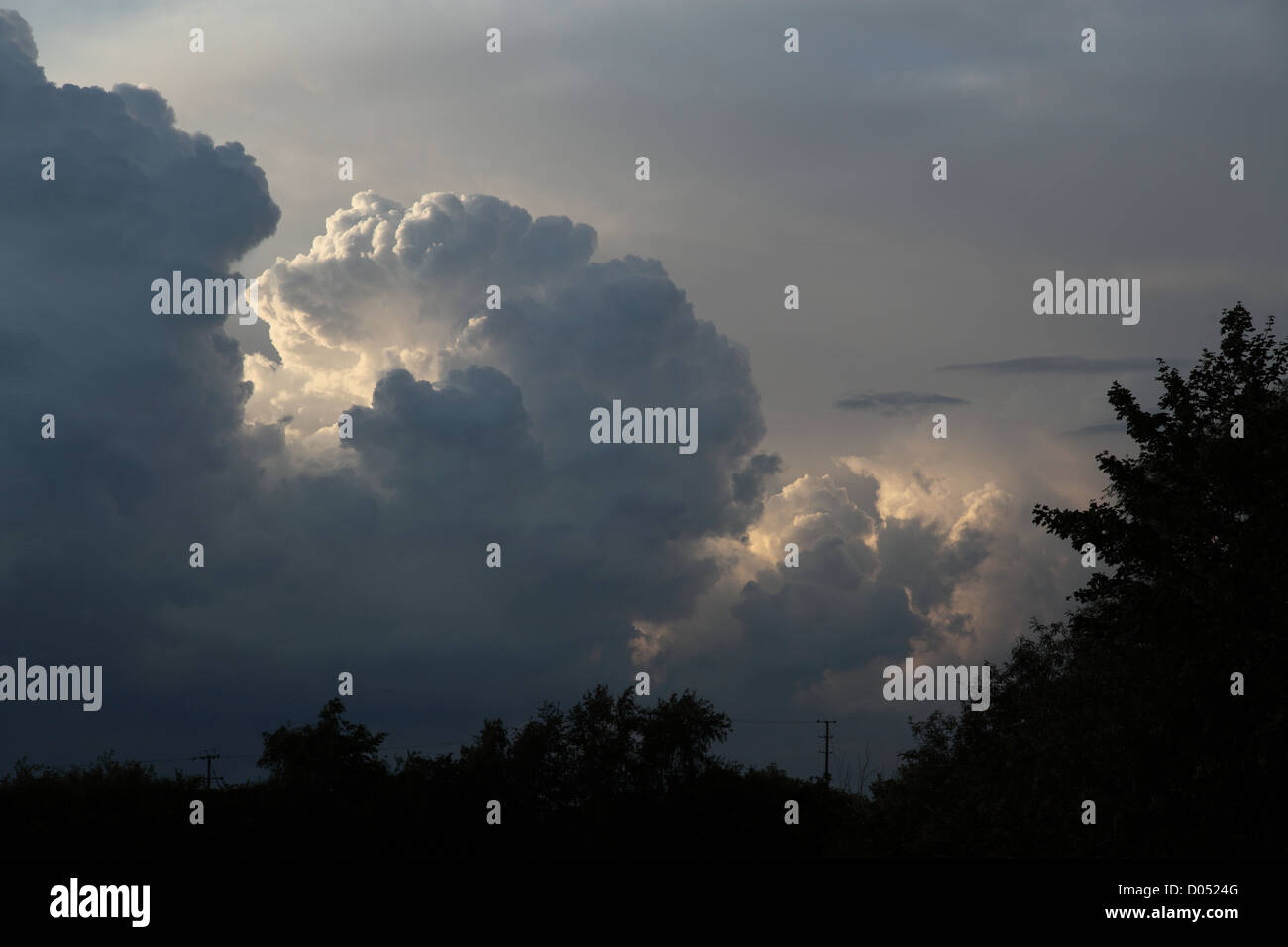 threatening cumulonimbus clouds seen in the UK in the late summer evening threatening a summer storm Stock Photo