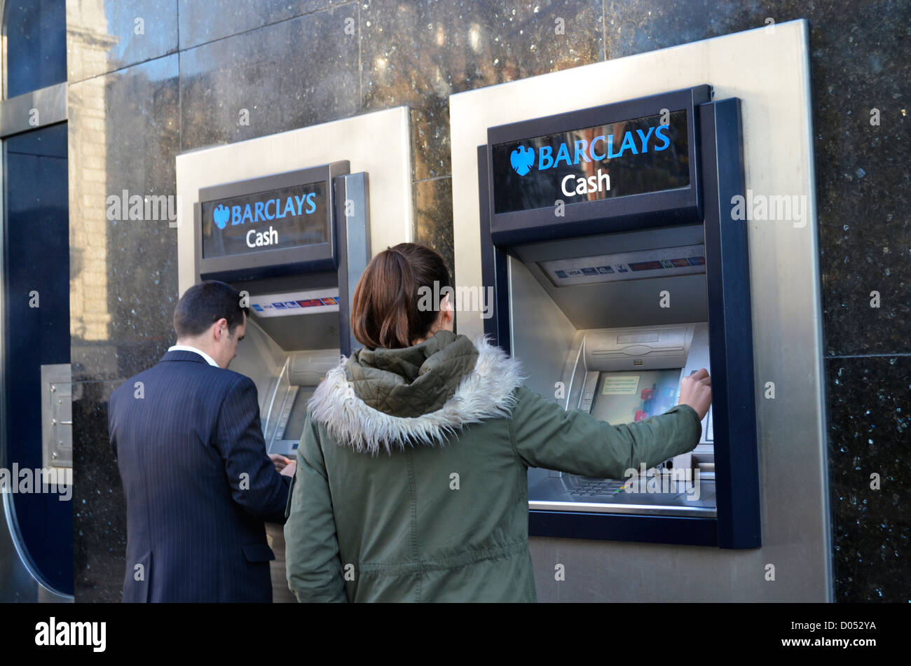 2 people at Barclays cash point London Stock Photo