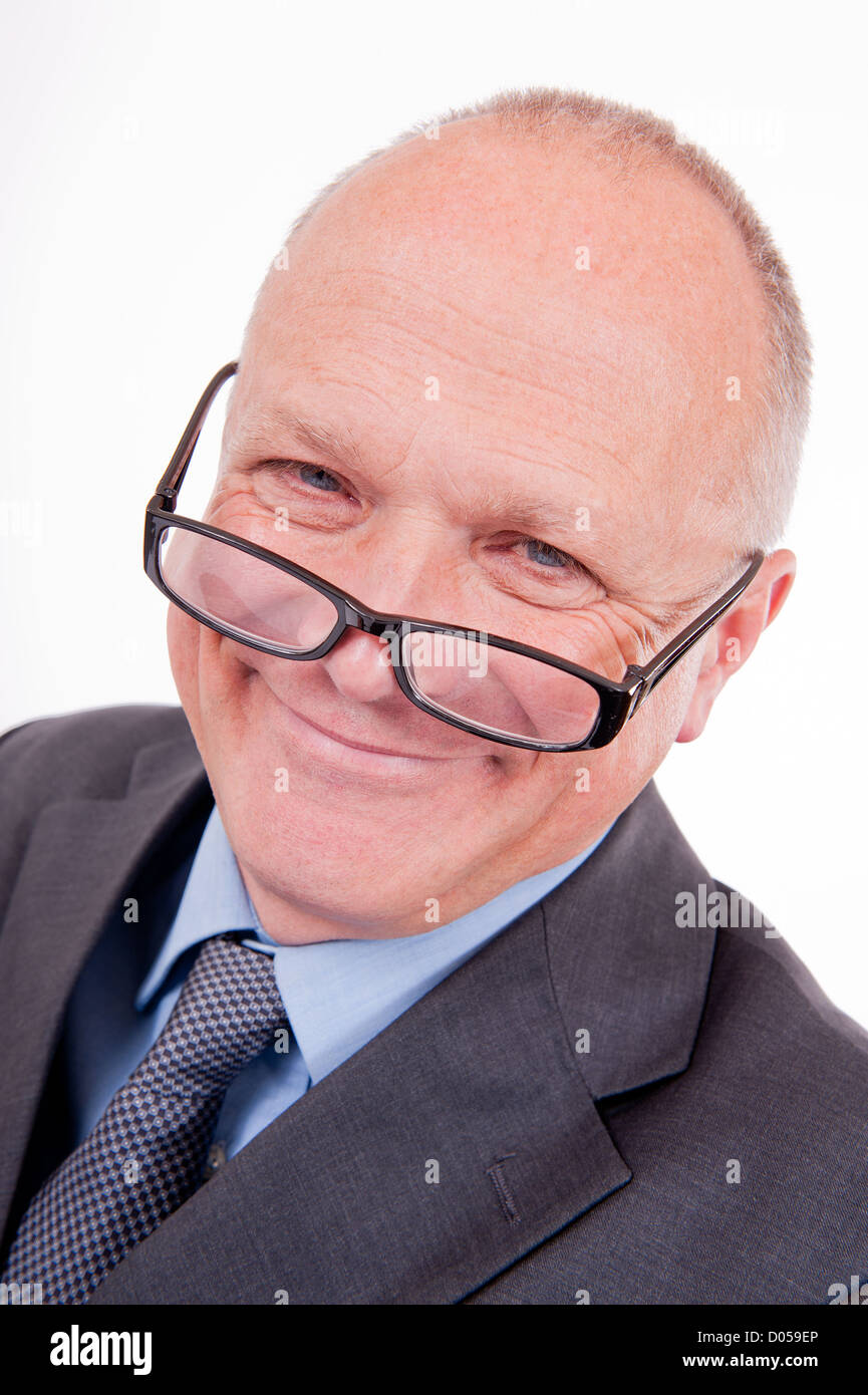 Portrait of a smiling businessman with his glasses at the end of his nose  Stock Photo - Alamy