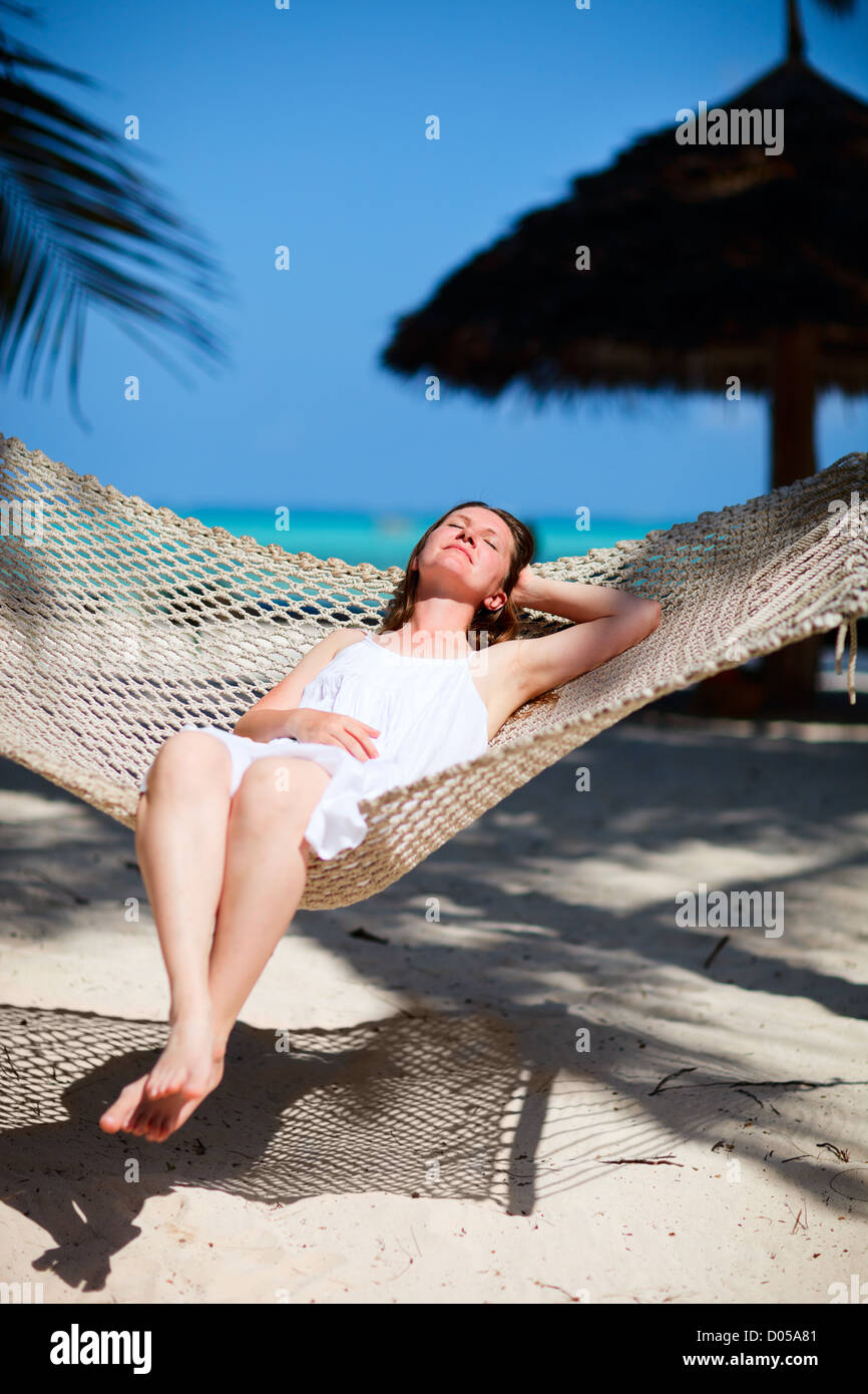 Woman relaxing in hammock Stock Photo - Alamy