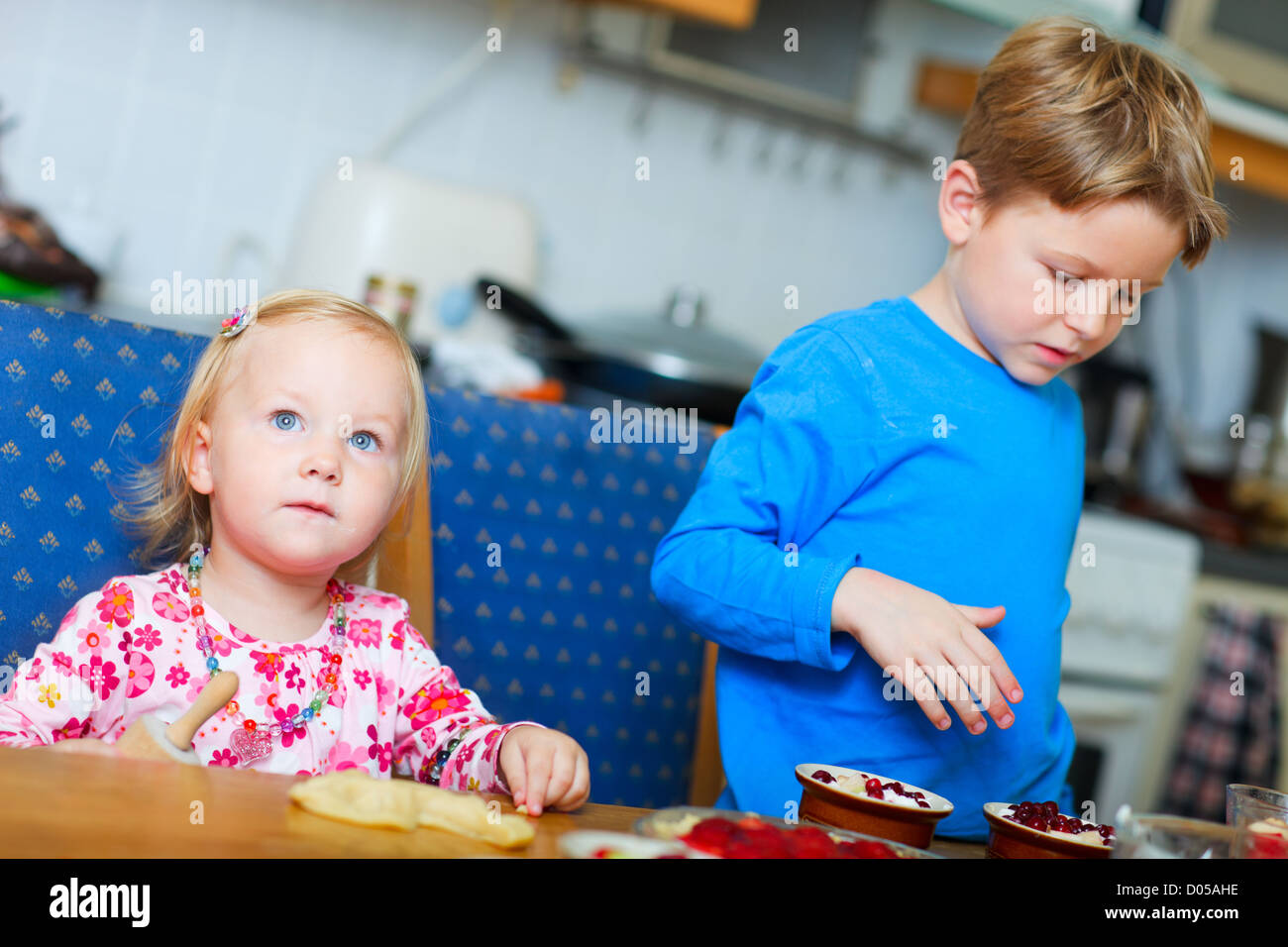 Two kids baking Stock Photo - Alamy