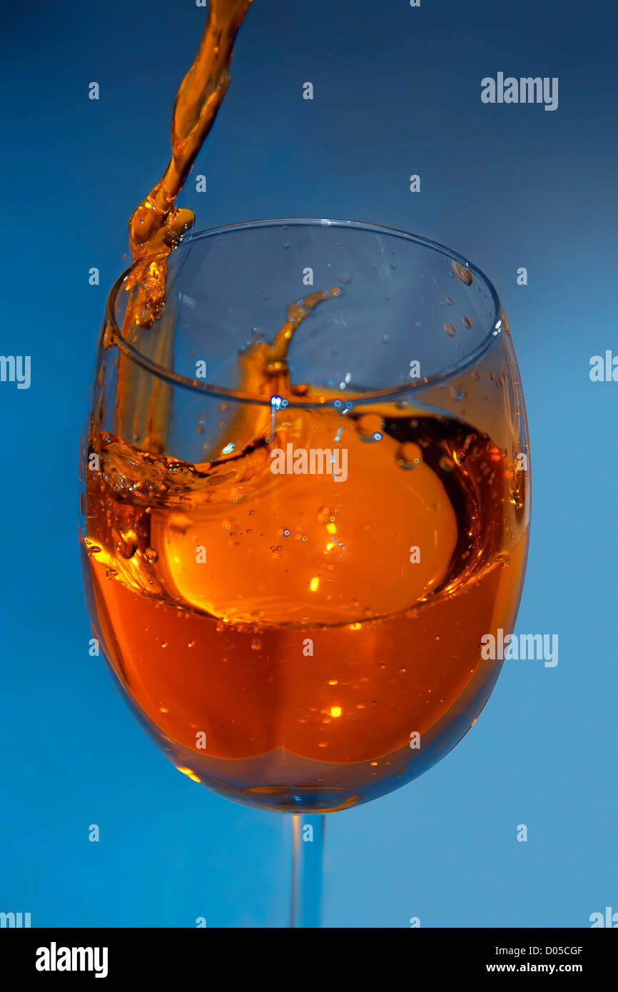 Glass with being poured water Stock Photo