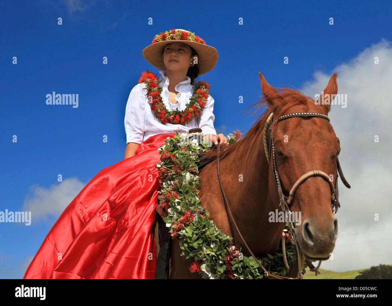 Young girl and horse adorned with floral decorations for the 35th annual Waimea Paniolo Parade on the Big Island Stock Photo