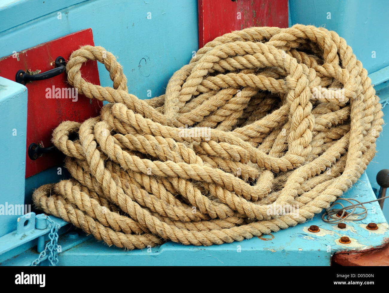 A coil of natural fibre rope in a fishing boat. Scrabster, Caithness, Scotland, UK. Stock Photo