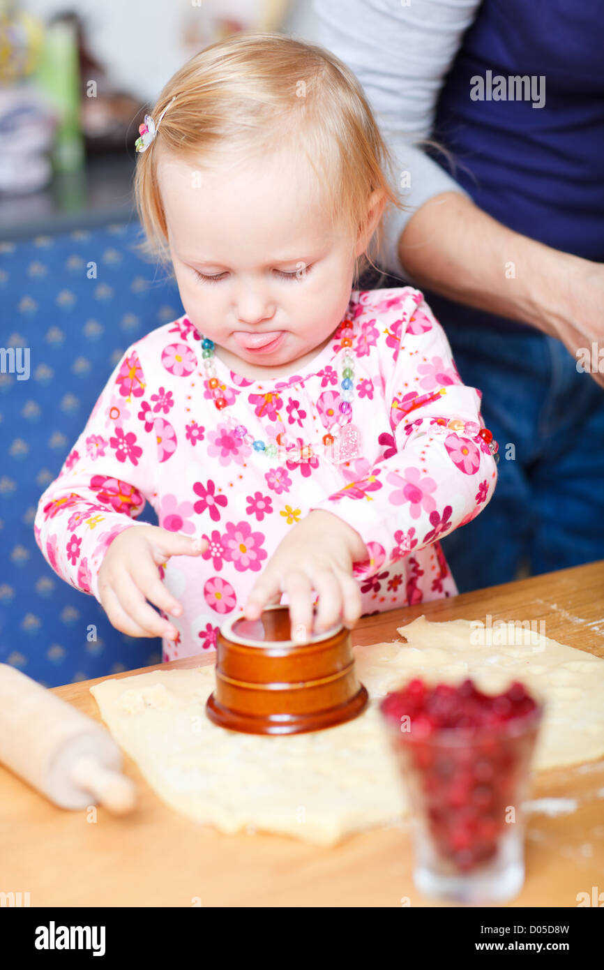 Adorable toddler girl helping at kitchen Stock Photo Alamy