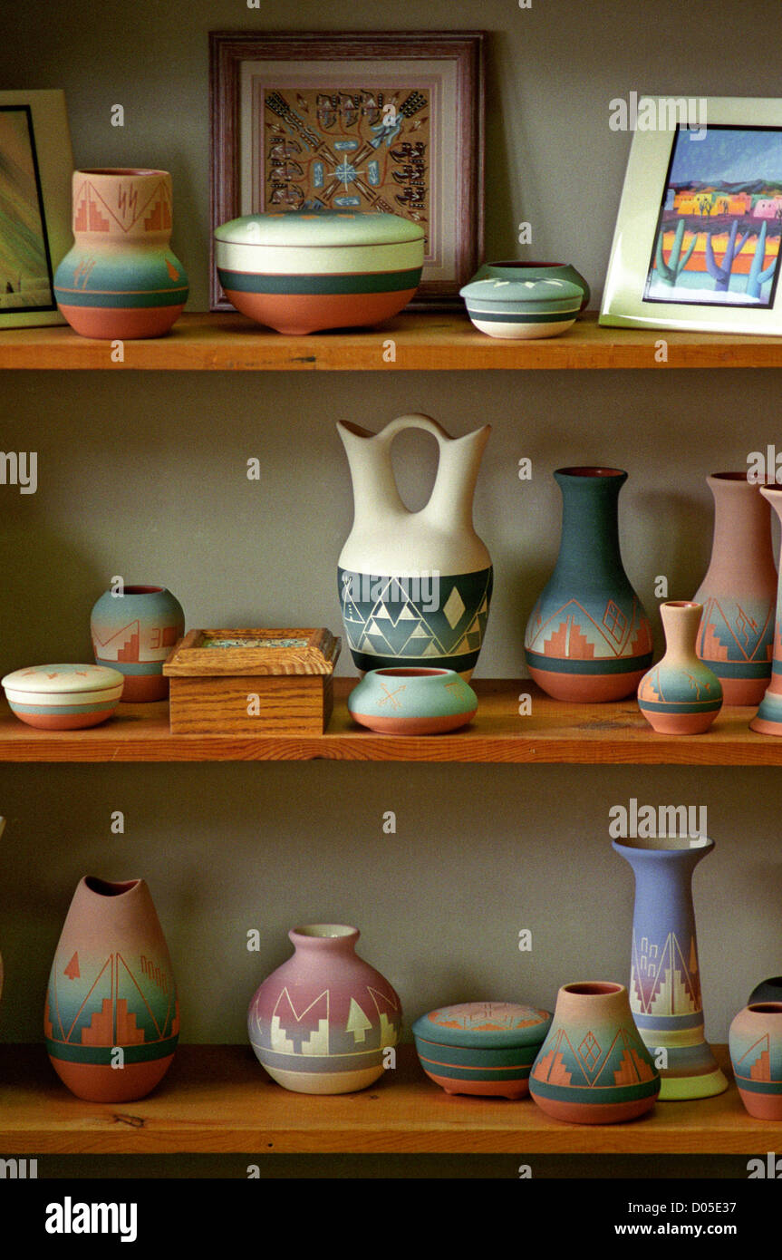 Various types of southwestern pottery and art line three wooden shelves