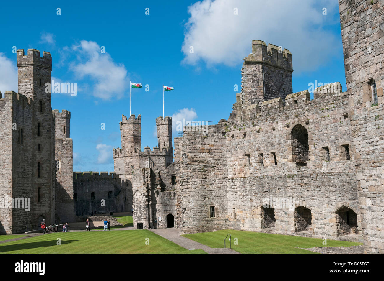 Wales, County Gwynedd, Caernarfon Castle, Welsh flags atop Eagle Tower Stock Photo