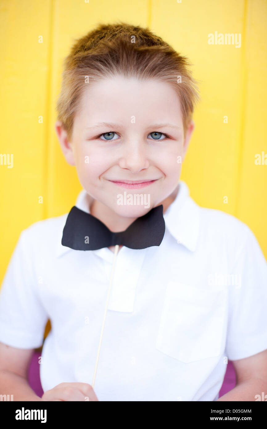 Cute boy with bow tie party accessory Stock Photo Alamy