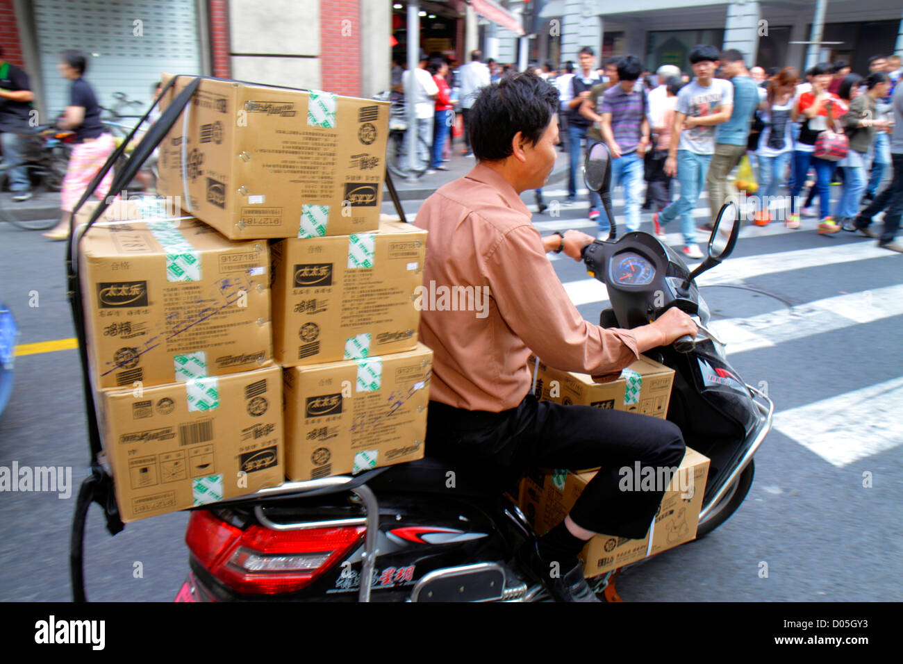 Shanghai China,Chinese Huangpu District,East Nanjing Road,National Day Golden Week,Asian man men male adult adults,street scene,motor scooter,boxes,de Stock Photo