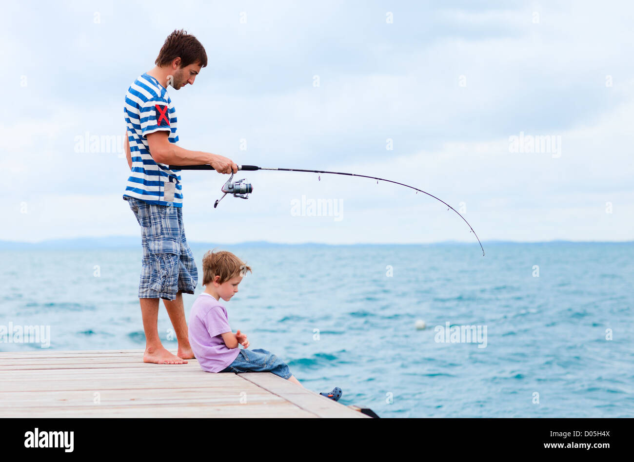 Father and son fishing together Stock Photo Alamy