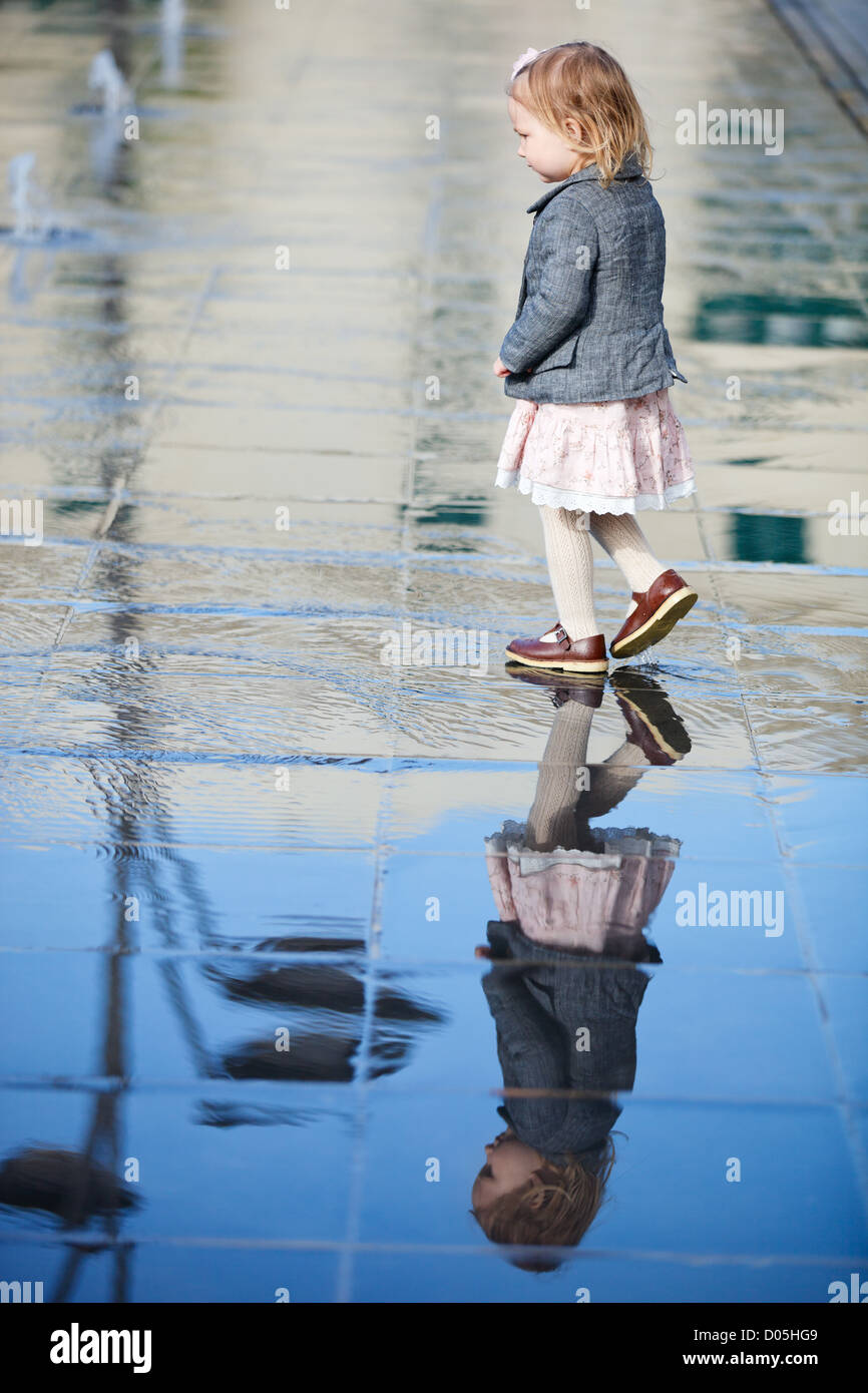Little girl playing in street fountain Stock Photo - Alamy
