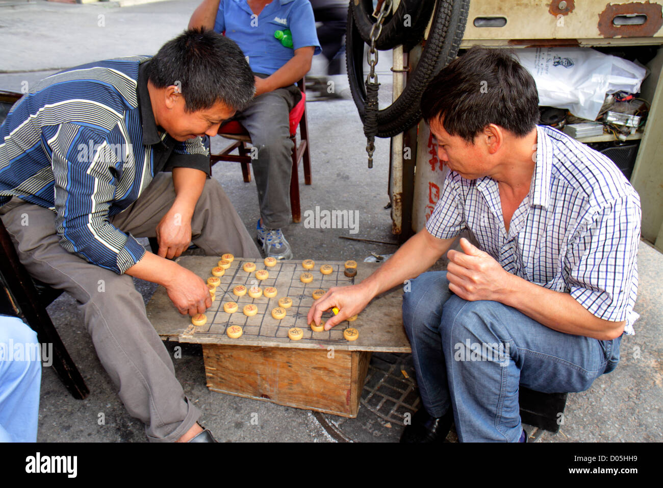 Shanghai China,Chinese Huangpu District,Sichuan Road,Asian man men male adult adults,playing board game,Xiangqi,Chinese Chess,street scene,China121003 Stock Photo