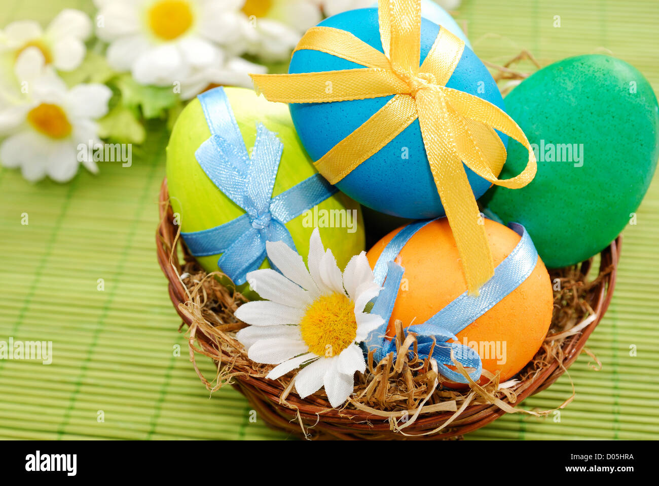 Colorful easter eggs in the basket on the green background Stock Photo ...