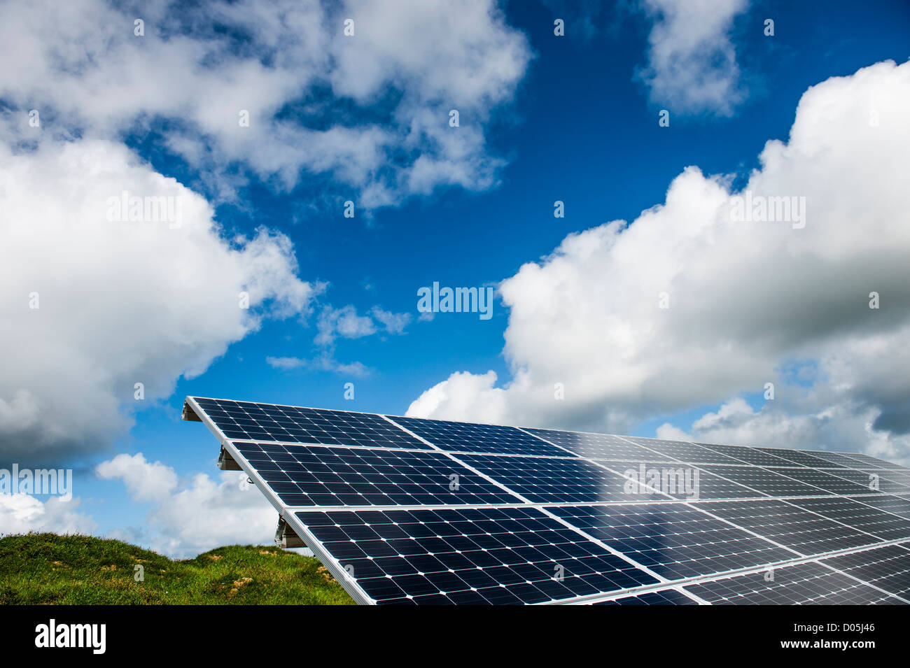 Green renewable energy: An array of solar panels converting sunshine into electricity, UK Stock Photo