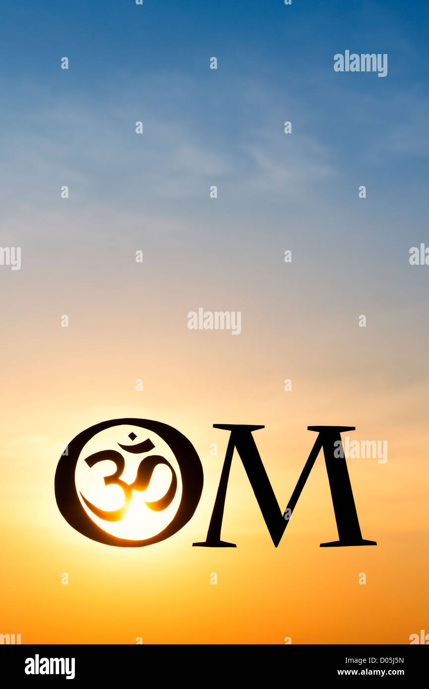 Hindu OM / AUM symbol silhouette at sunset in India Stock Photo