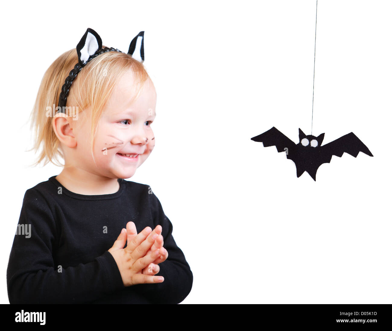 Toddler girl in black cat costume Stock Photo - Alamy