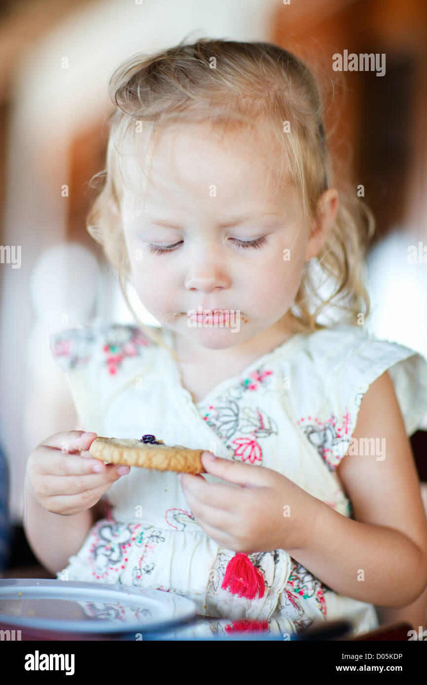 Girl eating cookie Stock Photo Alamy