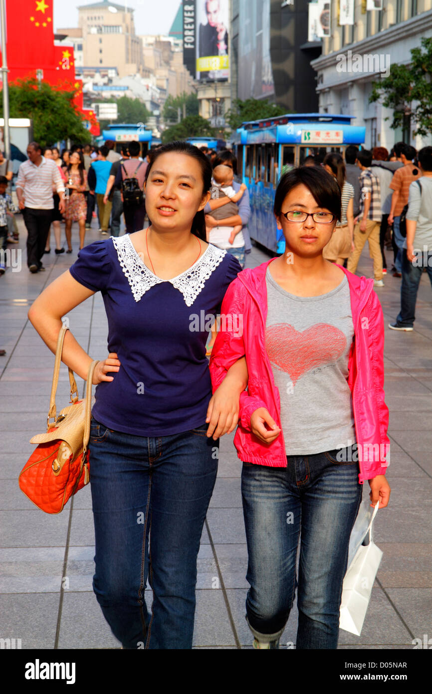 Shanghai China,Huangpu District,East Nanjing Road,pedestrian mall,Asian woman female women,arm in arm,National Day Golden Week,shopping shopper shoppe Stock Photo