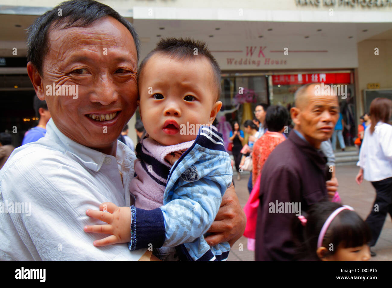 Shanghai China,Chinese Huangpu District,East Nanjing Road,Mandarin,hanzi,characters,symbols,Asian man men male adult adults,grandfather,dad,boy boys,m Stock Photo