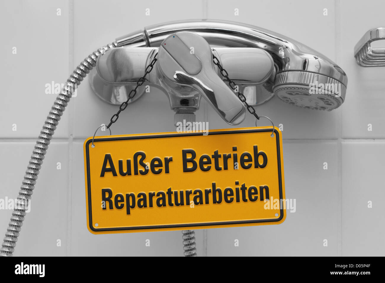 Detail photo of a shower. A sign "not working, repair work" in German