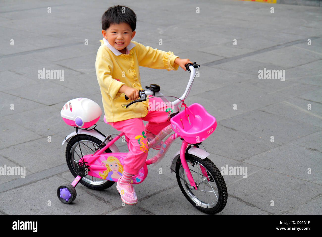 Shanghai China,Chinese Yangpu District,Siping Road,Asian girl girls,youngster,female kids children bicycle,bicycling,riding,biking,rider,training whee Stock Photo