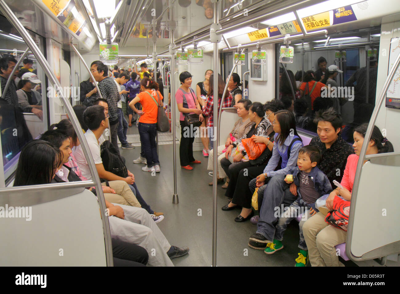 Shanghai China,Oriental,Yangpu District,Tongji University Metro Station,subway,train,train,Lavender Line 10,Asian woman female women,mother,man men ma Stock Photo