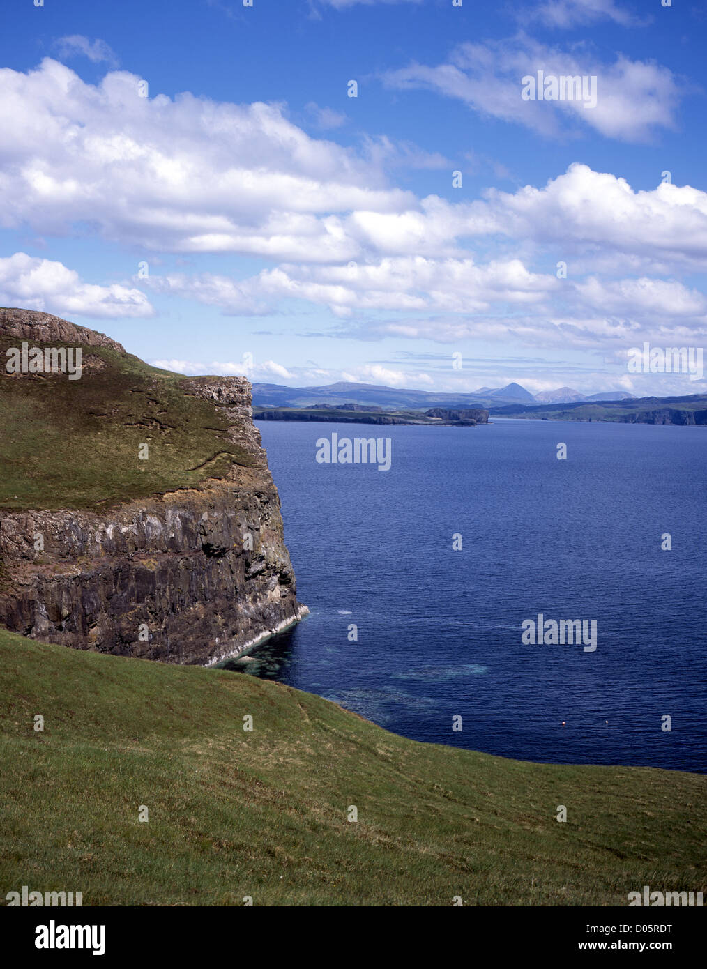 Cliffs and headland near Idrigill Point Loch Bracadale Orbost Duirinish Red Cuillin in the far distance Isle of Skye Scotland Stock Photo