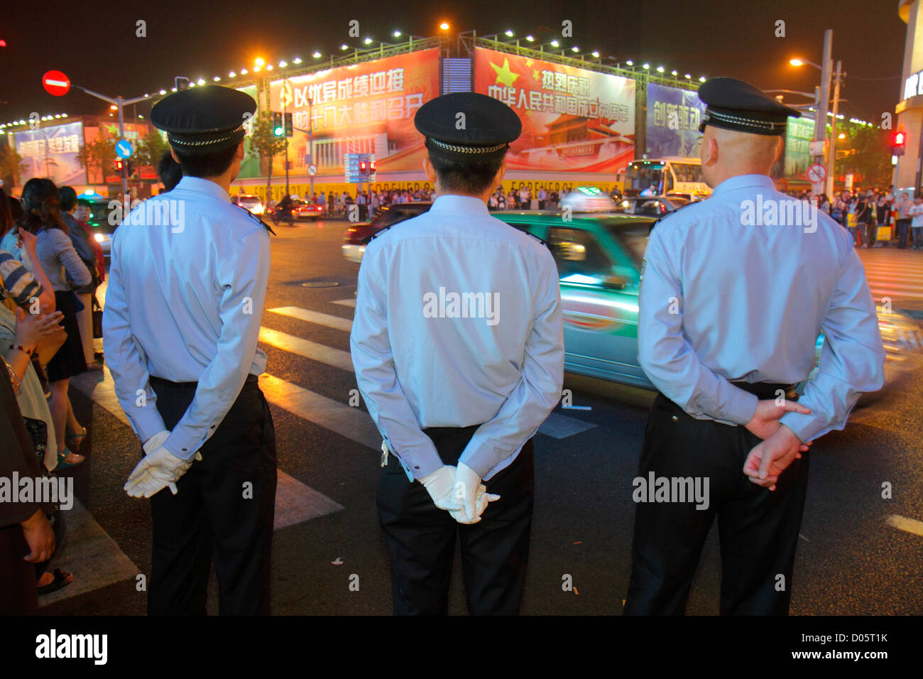 Shanghai China,Chinese Huangpu District,East Nanjing Road,National Day Golden Week,night evening,Asian man men male adult adults,police,policeman,Mand Stock Photo
