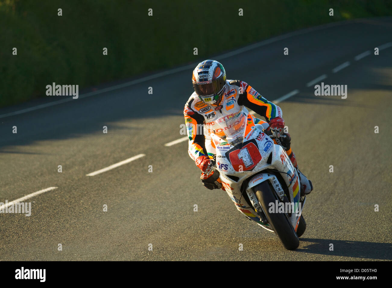 A photograph of John McGuinness approaching the 'Gooseneck' during the 2012 TT, on the Padgetts MMCG Superstock 1000. Stock Photo
