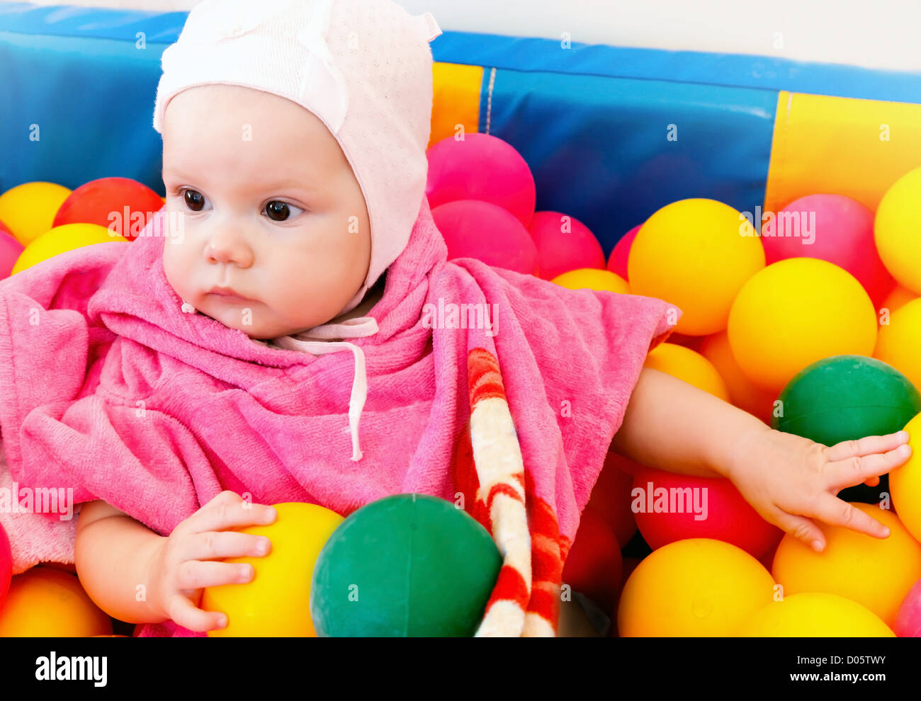 Little baby girl plays with colorful balls Stock Photo Alamy