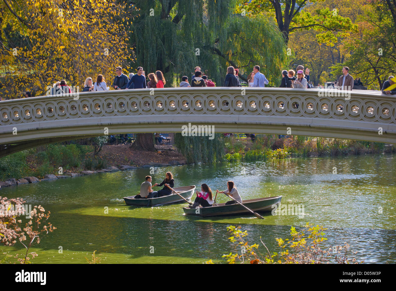 Visitors taking in the sights from the Bow Bridge in Central Park, New York, USA Stock Photo