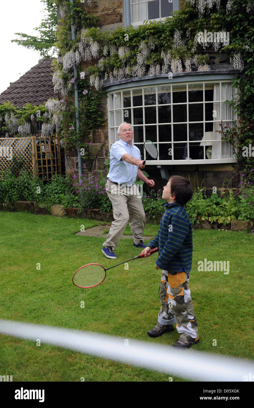 Grandparent playing badminton in the garden with his grandson in north yorkshire, uk Stock Photo