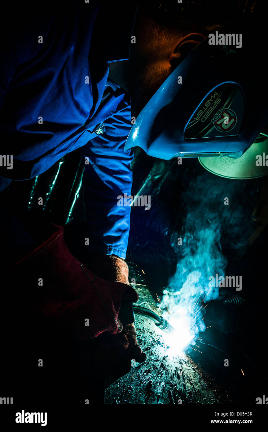 A teacher demonstrating the safe use of welding equipment at a secondary comprehensive school
