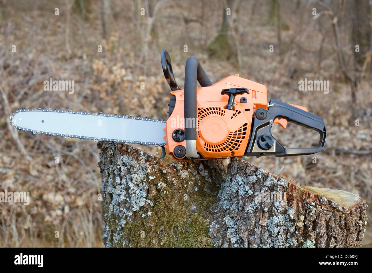 Orange Chain Saw on Log Stock Photo