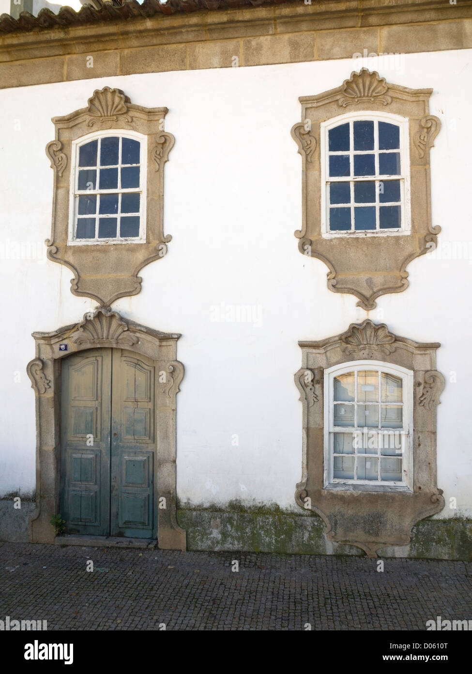 Ornamented stone framed windows and door Stock Photo