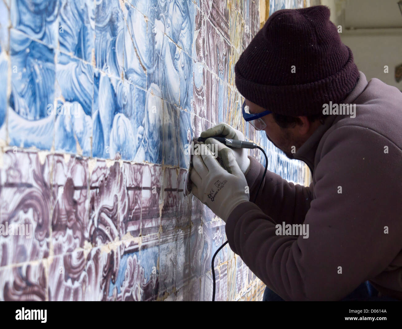 Man restoring traditional portuguese azulejos painted tiles Stock Photo