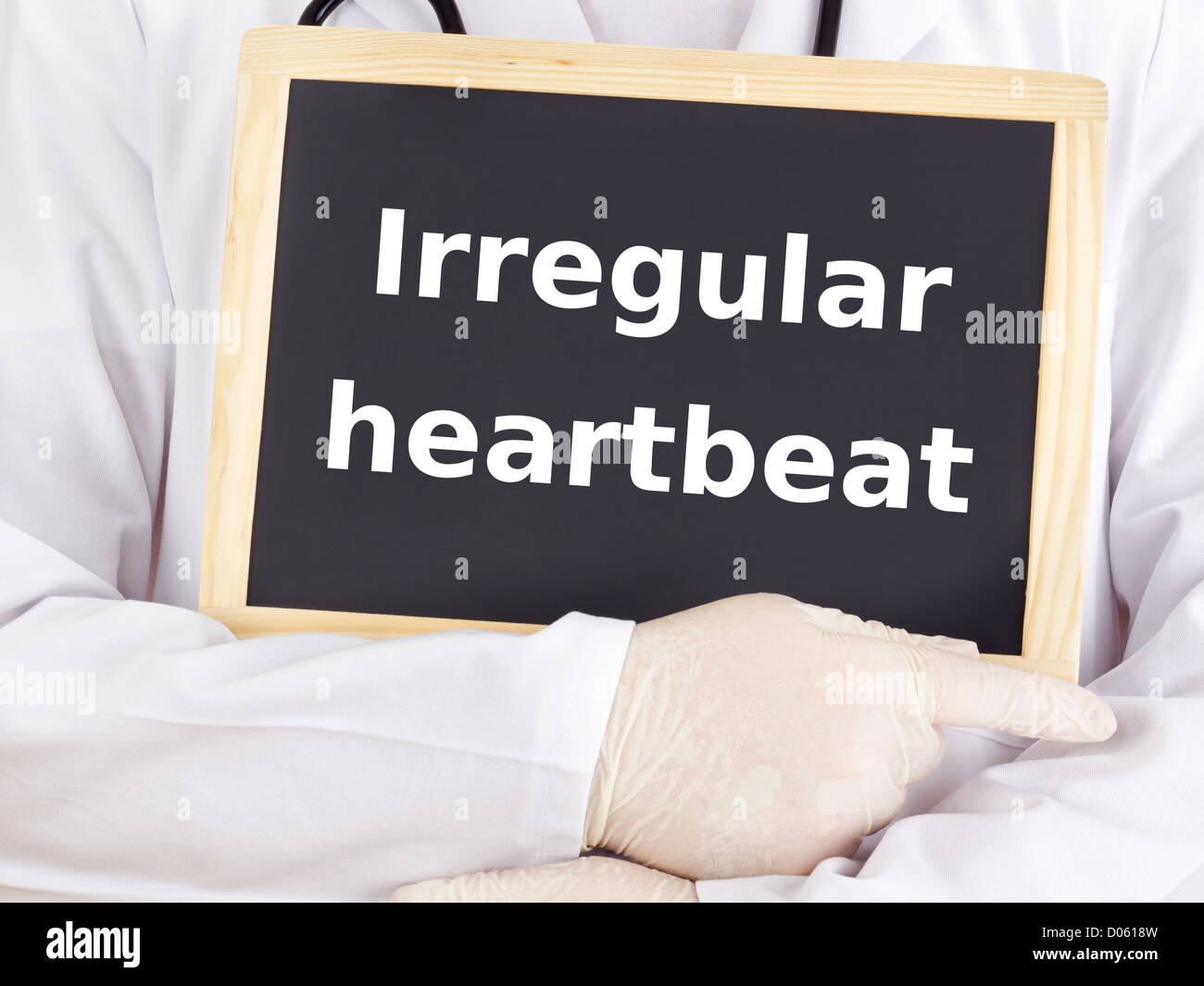 Doctor shows information: irregular heartbeat Stock Photo