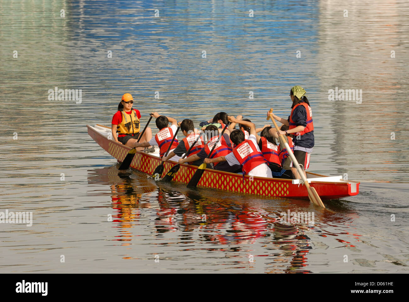 Young teens training on a dragon boat on the waters of False Creek, Vancouver BC Stock Photo