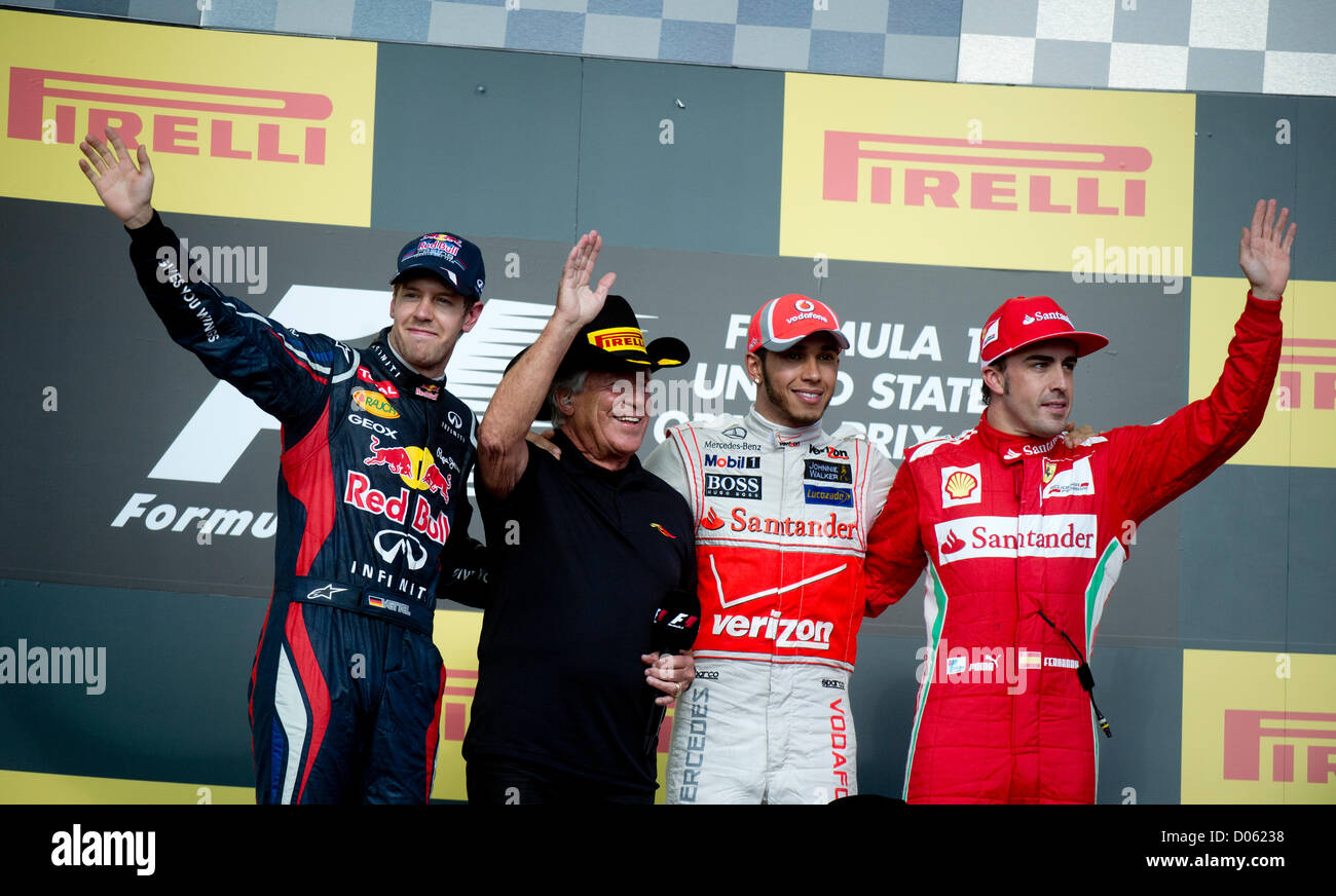 Sebastian Vettel (far left), Mario Andretti (l), winner Lewis Hamilton and Fernando Alonso (r) at F1 United States Grand Prix Stock Photo