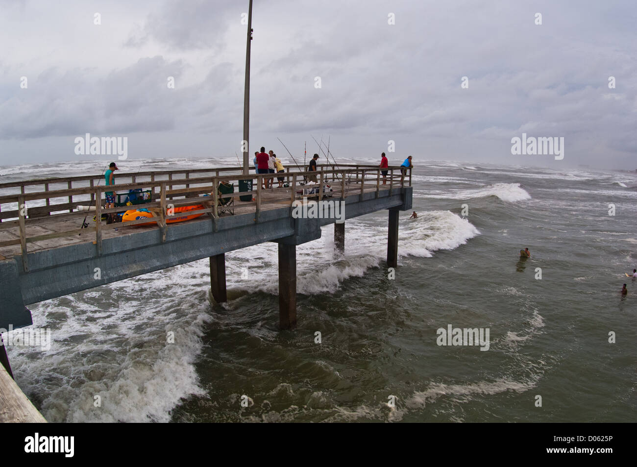 Surfers and fishermen at Horace Caldwell Pier during Hurricane Emily, Port Aransas Texas Stock Photo