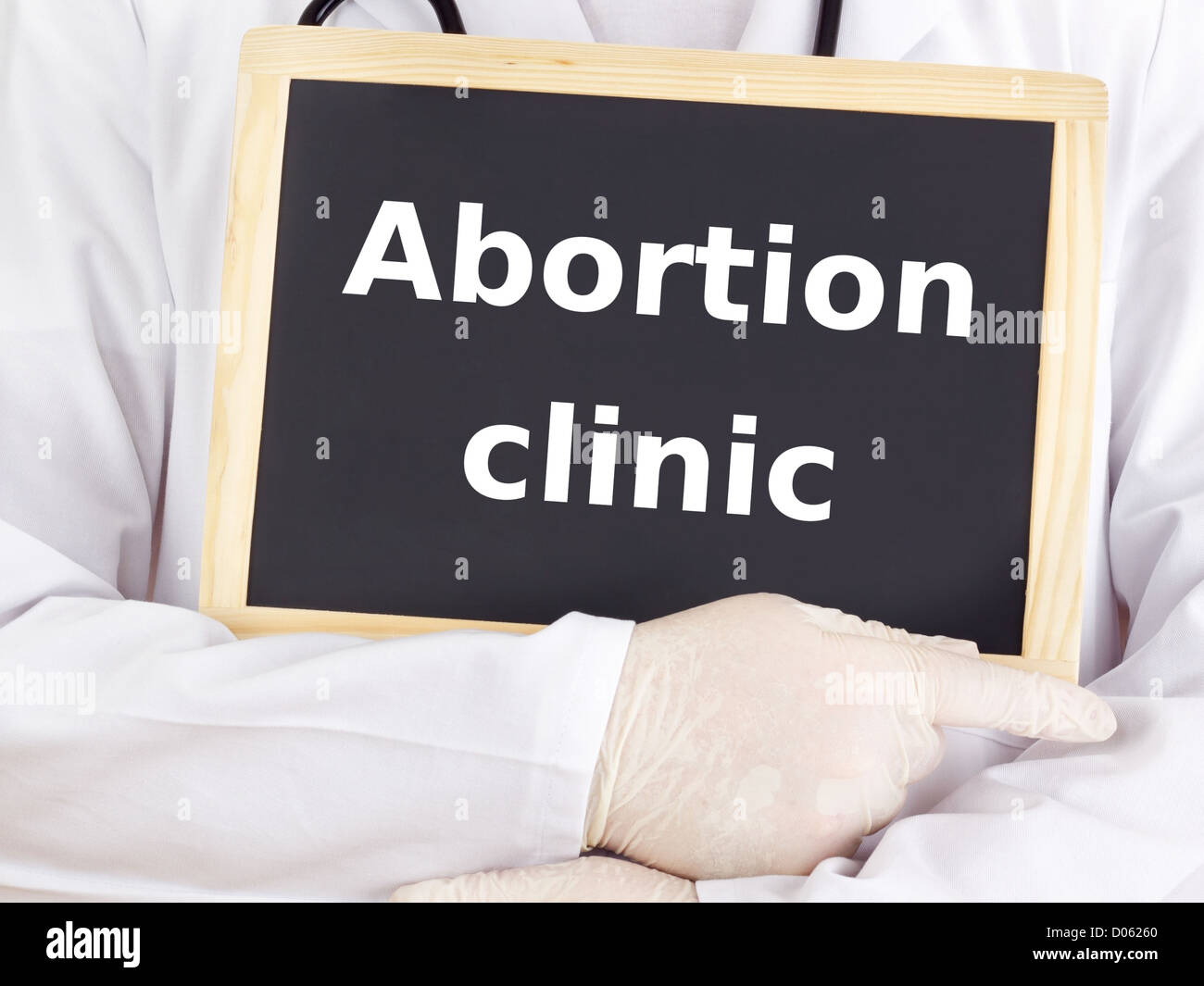 Doctor shows information on blackboard: abortion clinic Stock Photo