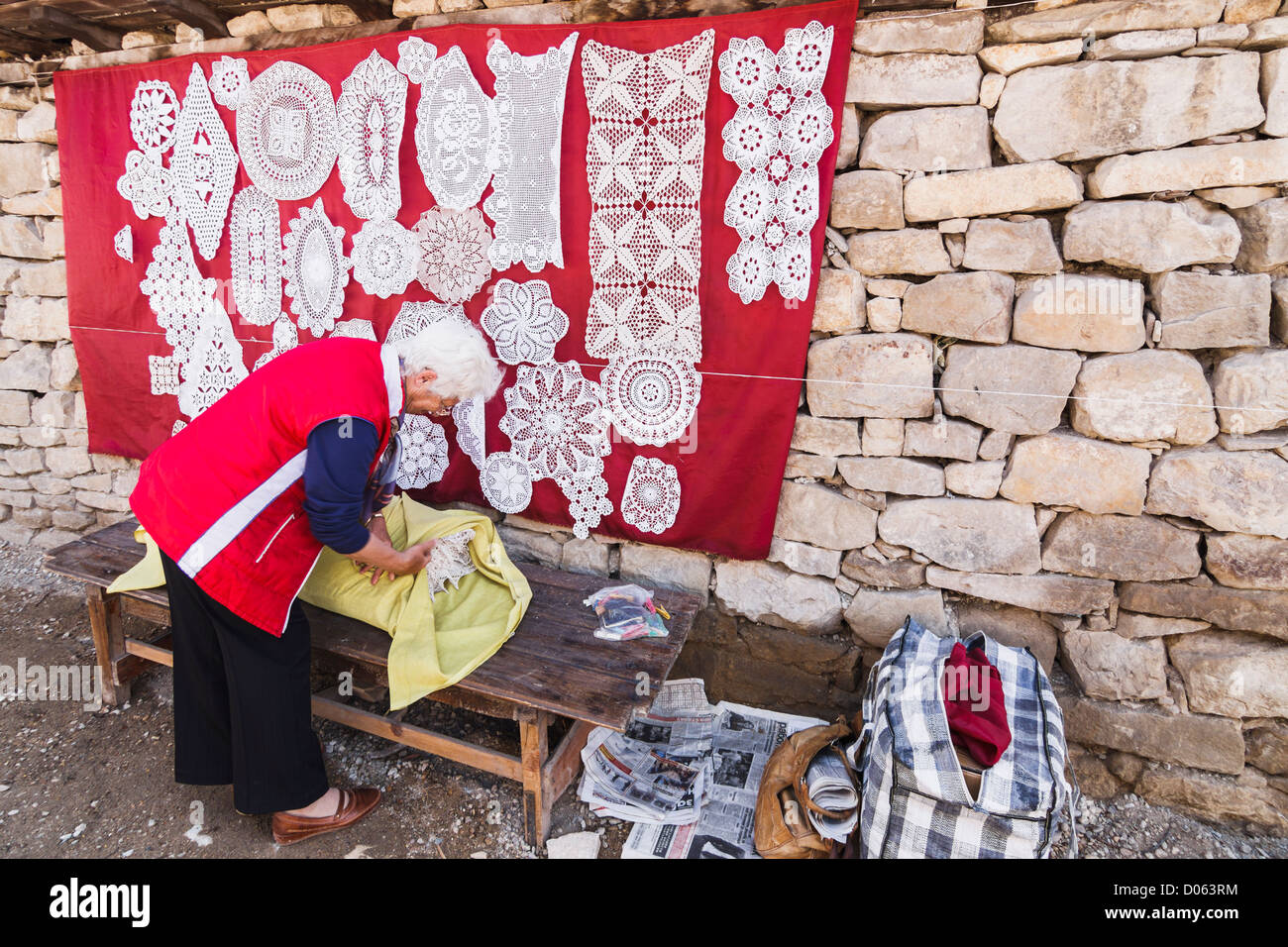 Old woman selling traditional embroidering in Arbanasi village, 4 kms from Veliko Tarnovo, Bulgaria Stock Photo