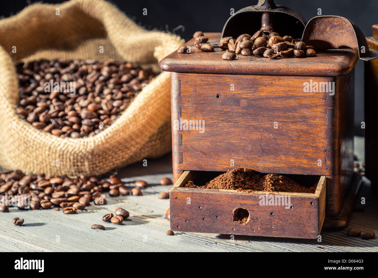 Ground coffee in vintage grinder and beans in sack Stock Photo - Alamy